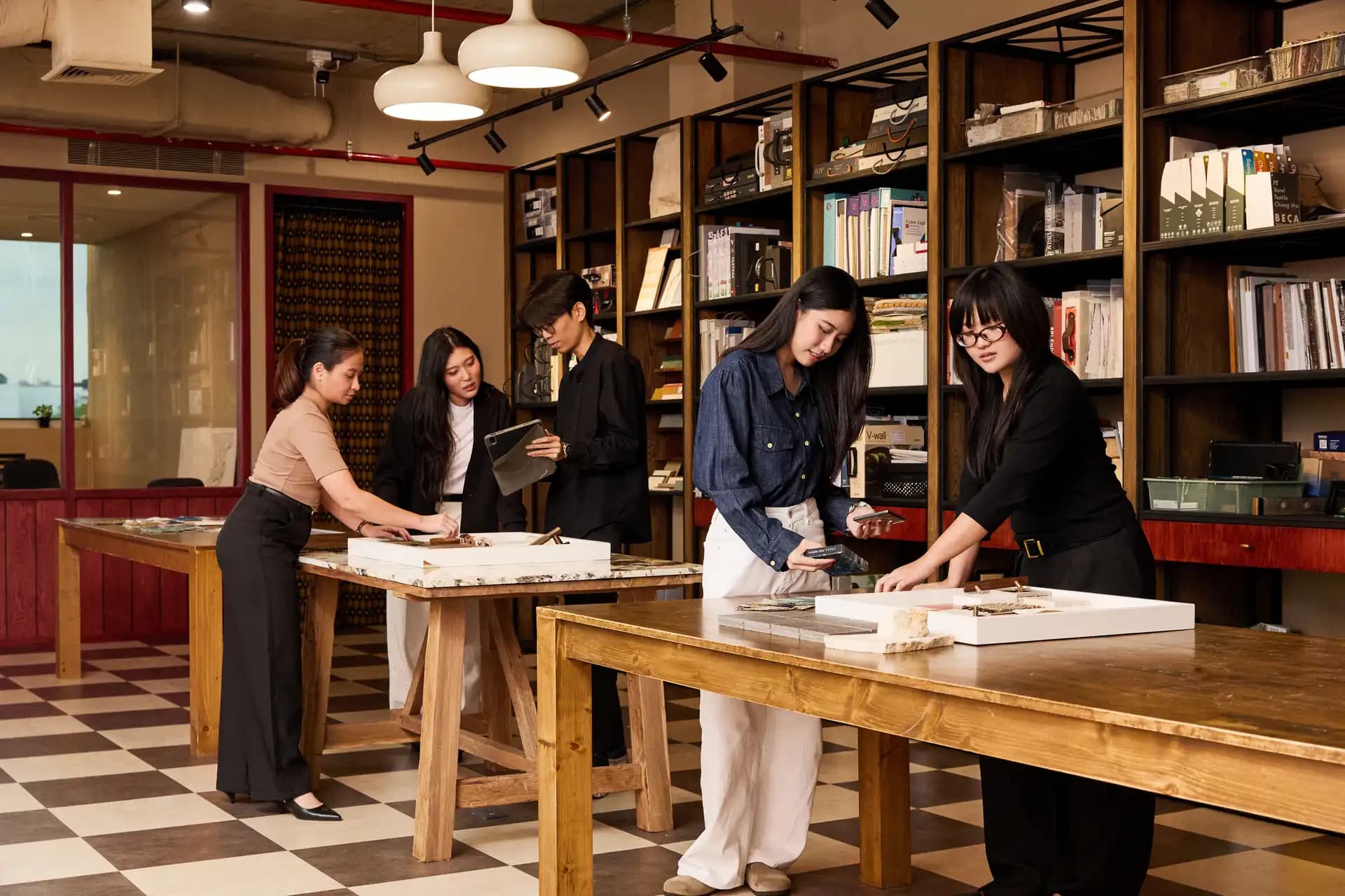 Designers discussing material choices in front of the sample library
