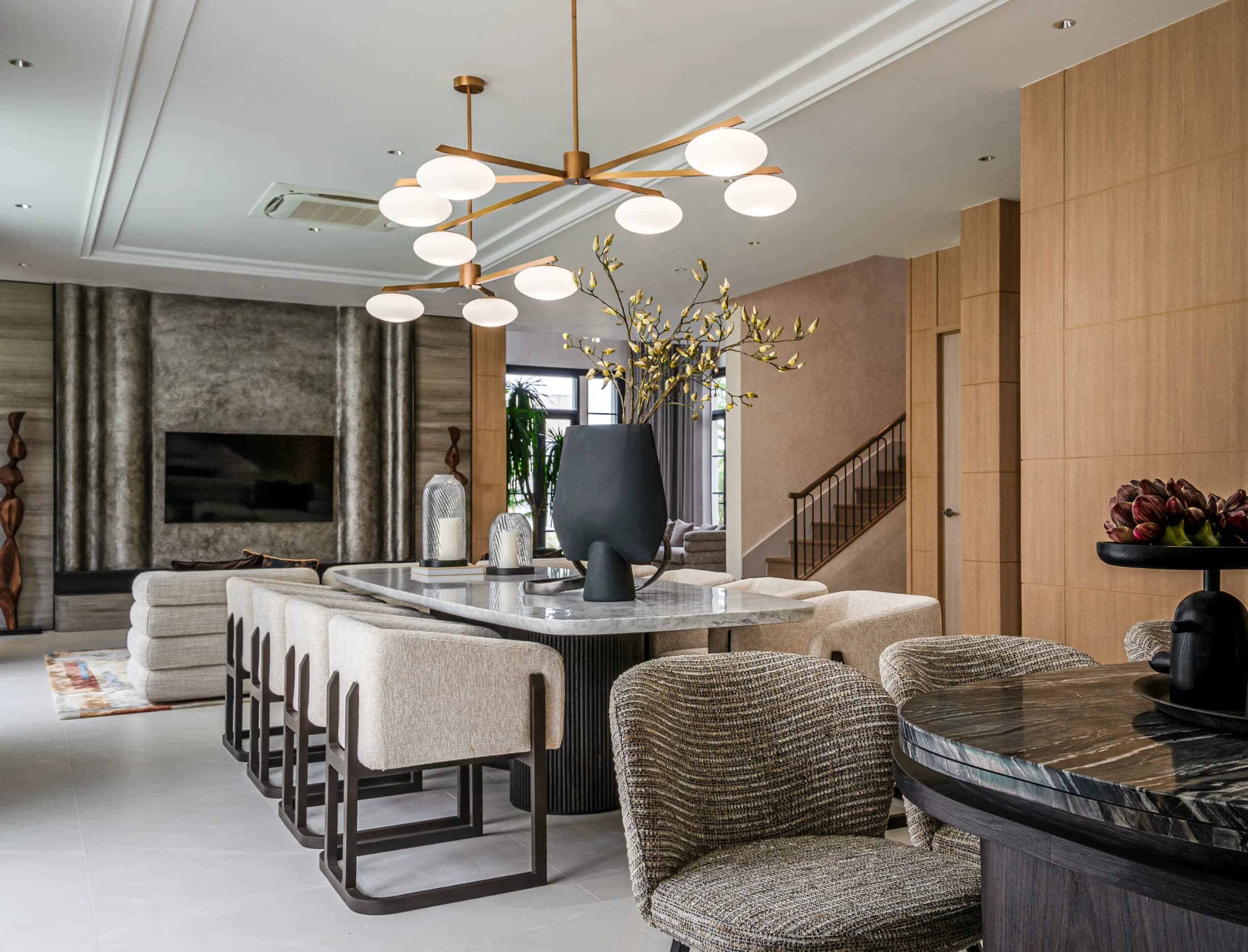 SIWA residence living and dining room with layered natural materials and sculptural lighting