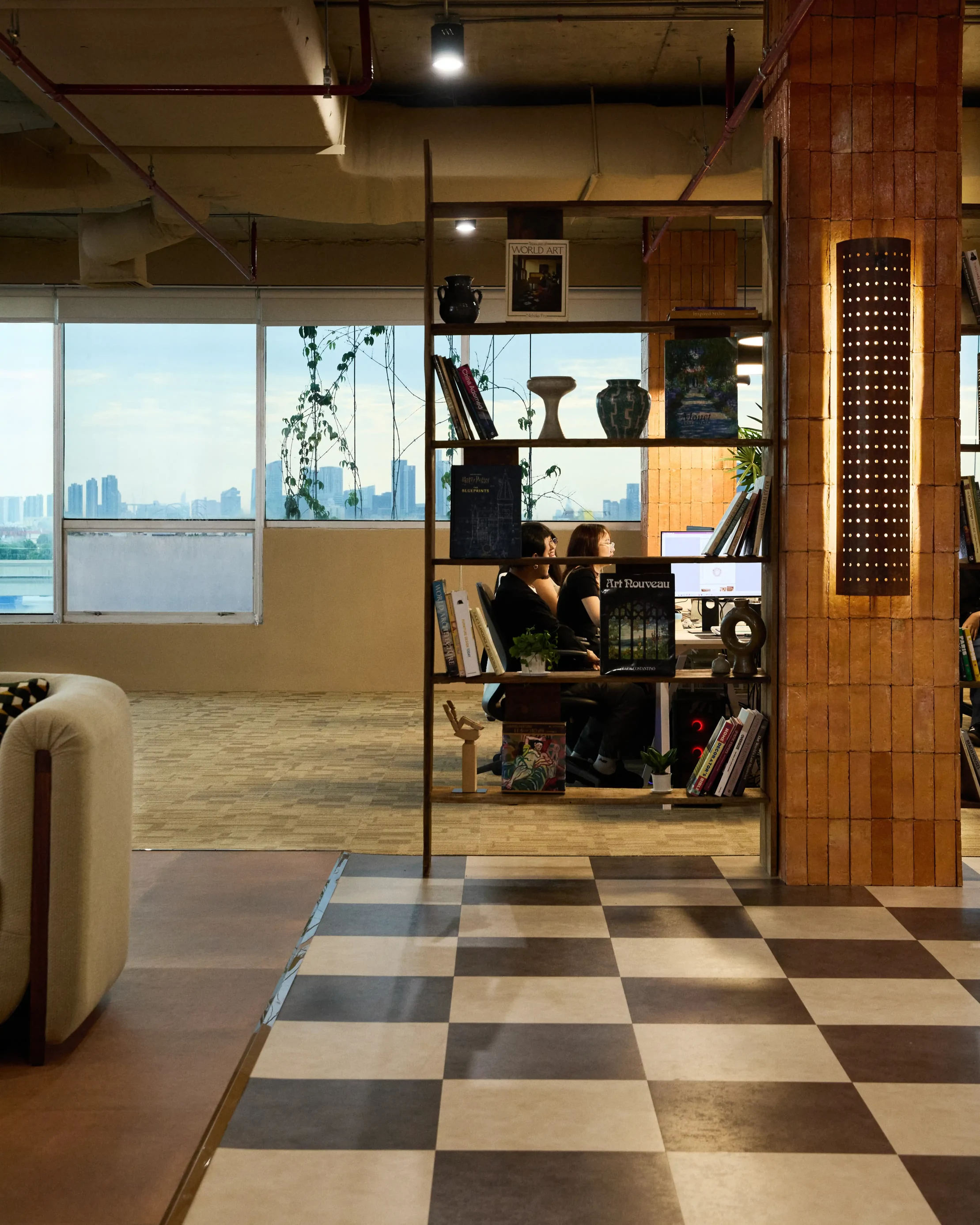 View through bookshelf of workstation by window