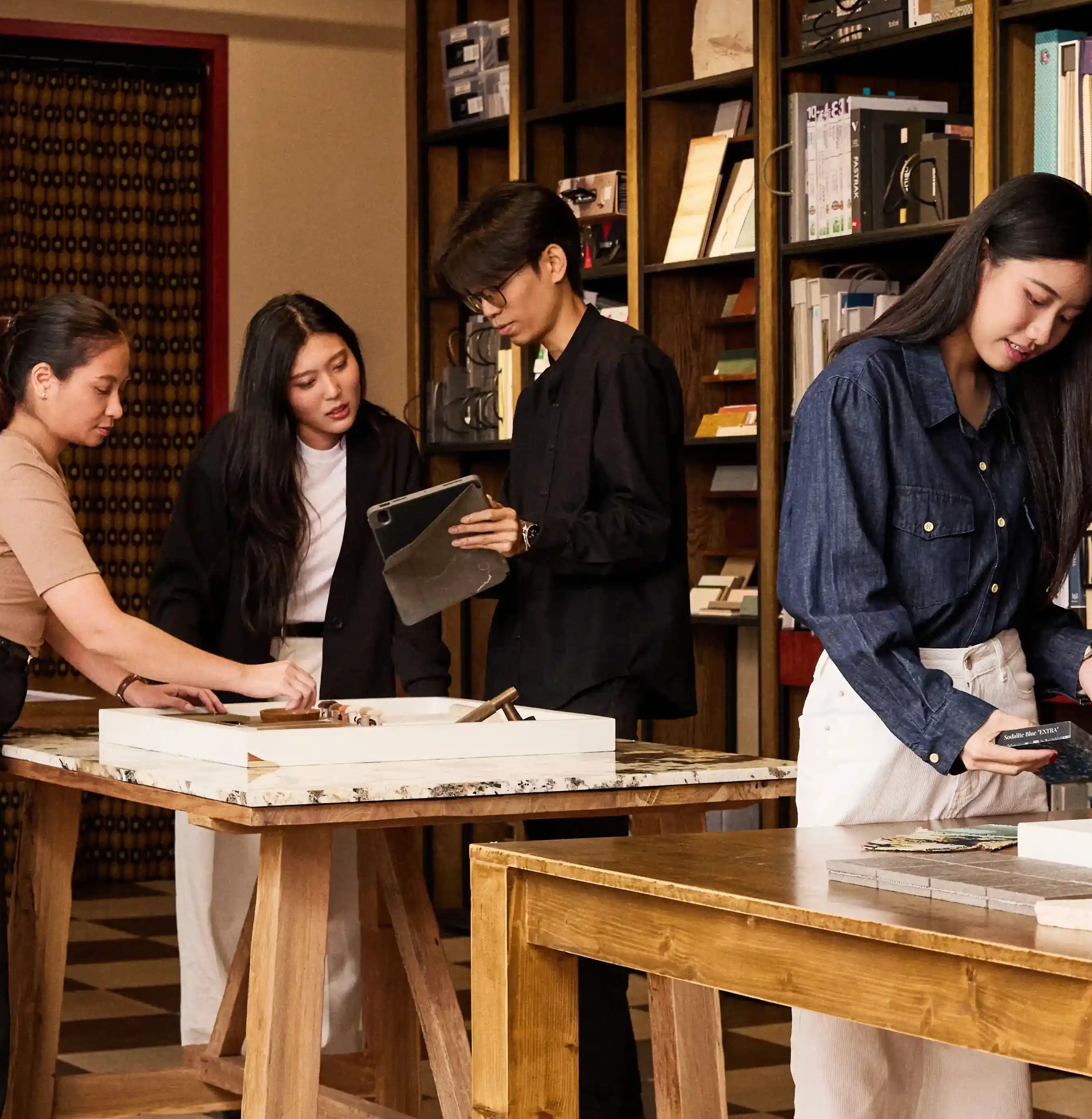 Team members inspecting architectural scale model