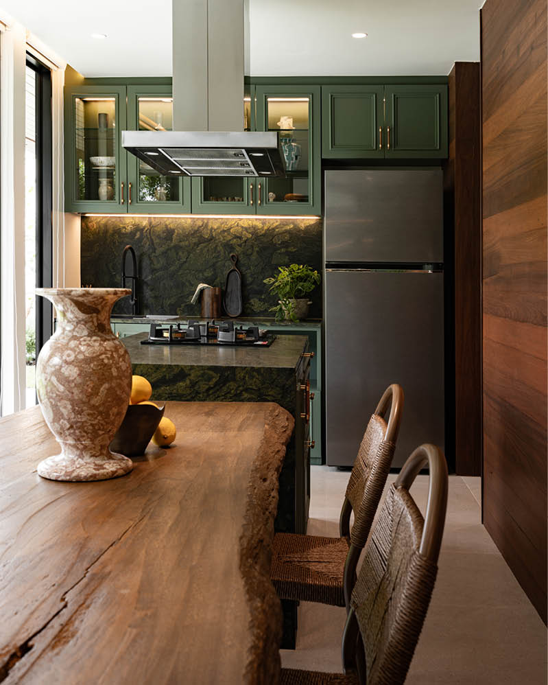 SIWA House kitchen with green cabinetry and live-edge timber table