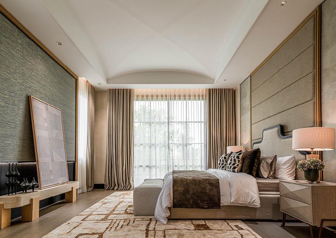 Master bedroom with a barrel-vault ceiling and grasscloth wall