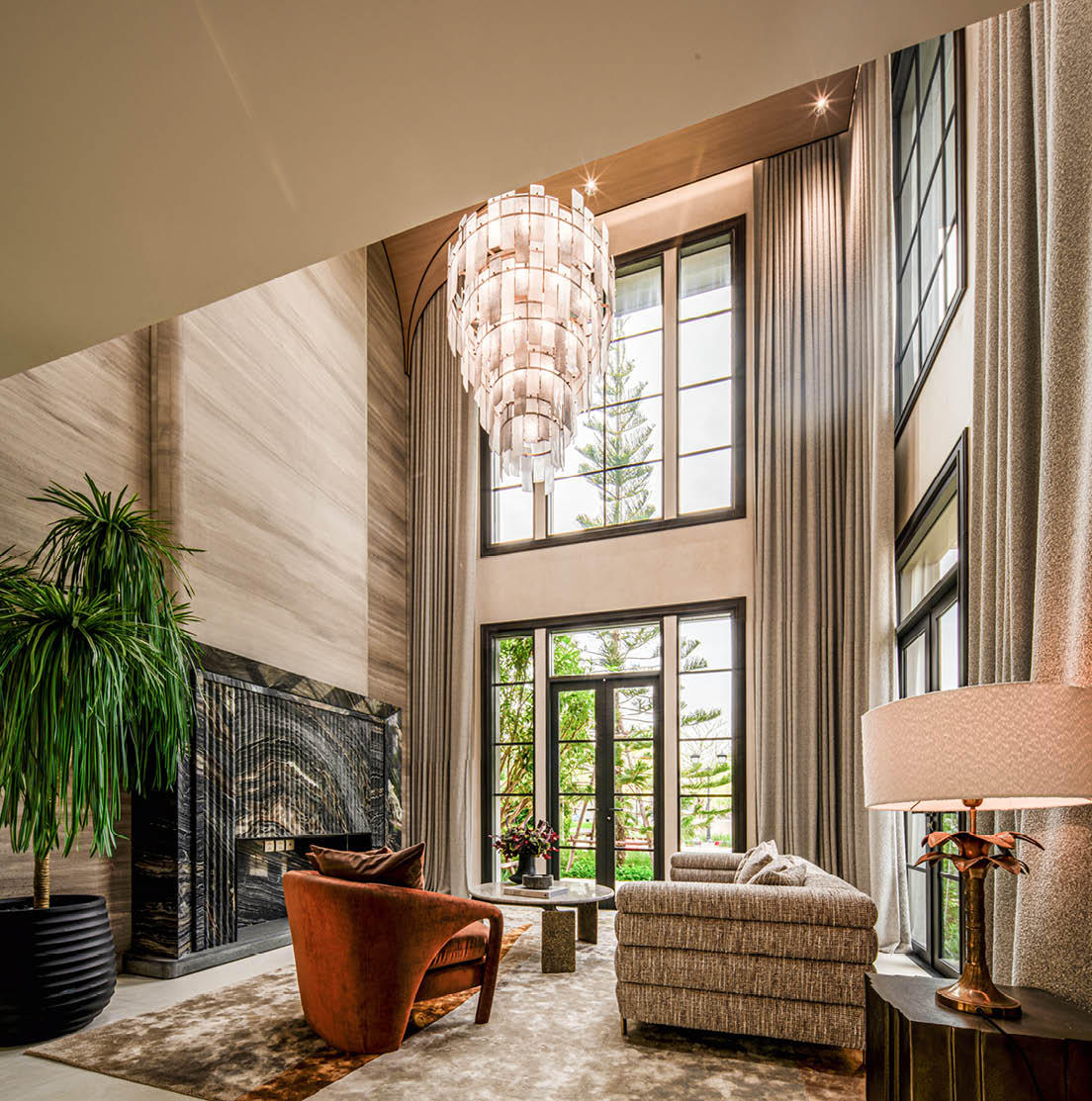 Double-height grand living hall with a tiered glass chandelier