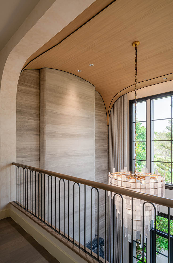 Upper walkway with a curved timber ceiling and chandelier